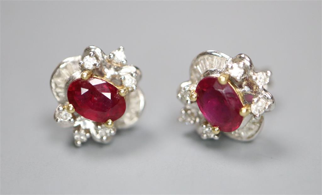 A modern pair of white metal (stamped 750), ruby and diamond cluster ear studs, 10mm, gross 2.3 grams.